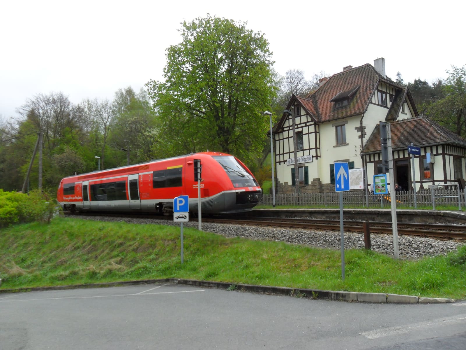Ein roter Triebwagen der Schwarzatalbahn hält am Bahnhof Bechstedt-Trippstein
