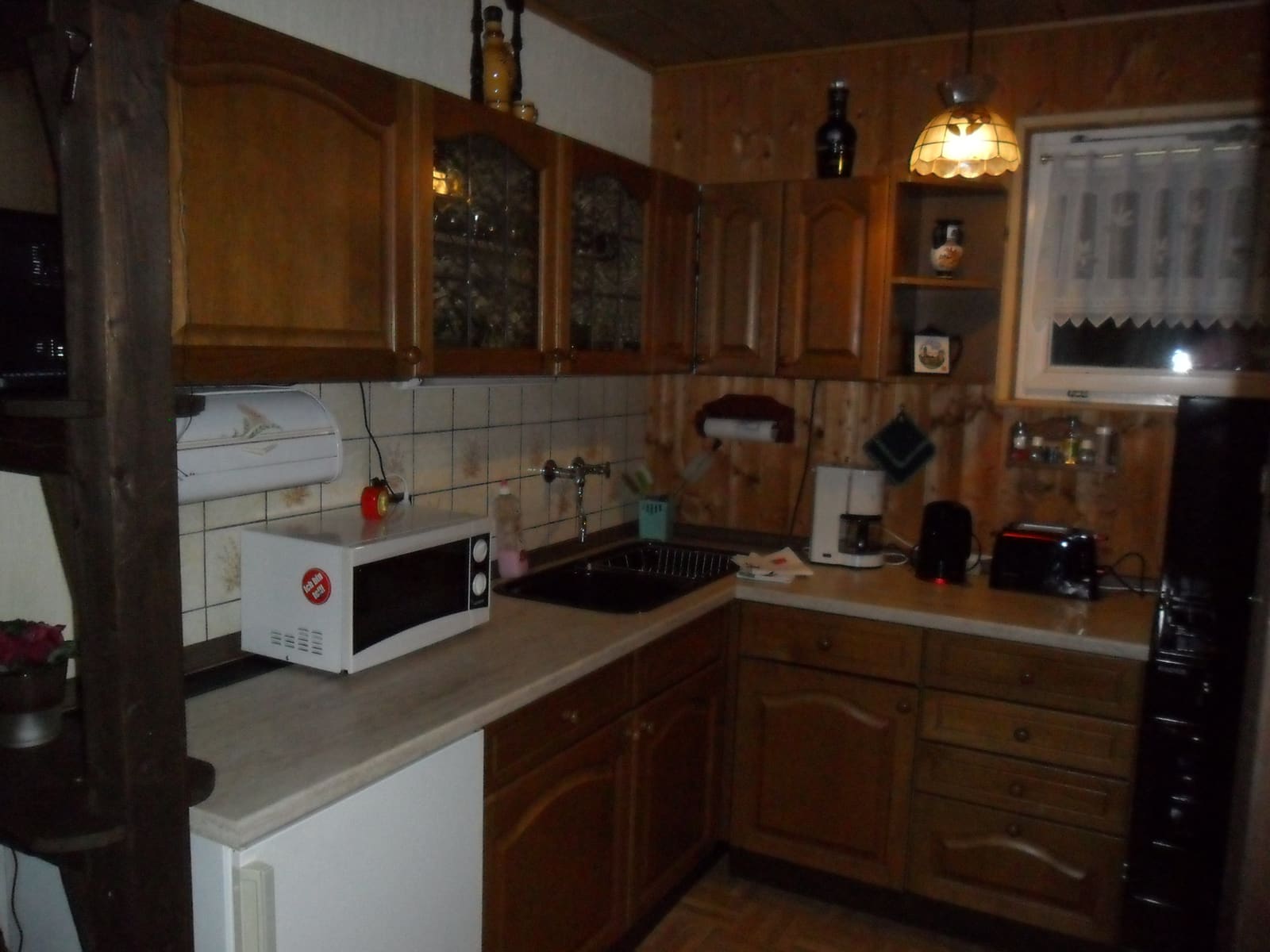 Küchenzeile im Bungalow mit Herd, Mikrowelle, Kaffeemaschine und Toaster